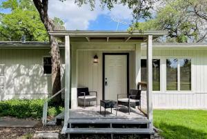 a porch with chairs and a table on a house at SLAUGHTER in Austin
