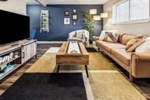 a living room with a couch and a tv at Delightful 1BD AT and T Walkable in Arlington