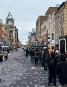 a crowd of people walking down a city street at Historic Downtown Apartment 2BD Retreat in London