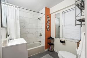 a bathroom with a sink and a tub and a toilet at Uplifting 2BD House in the heart of FortWorth in Fort Worth +24 photos