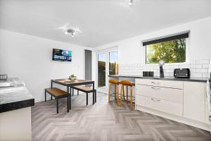 a kitchen with a table and a dining room at "Chez Nous" Perfect for contractors or families Sleeps 8 in Halesowen