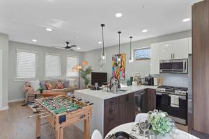 a living room with a table with a game at A La mode 2BD Townhouse 7TH St walkable in Fort Worth