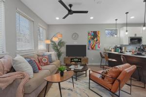 a living room with a couch and a tv at A La mode 2BD Townhouse 7TH St walkable in Fort Worth
