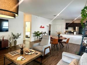 a living room and kitchen with a table and a couch at TONKA in Austin