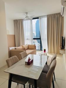 a living room with a table and a couch at Majestic Residence KLCC By AFA in Kuala Lumpur