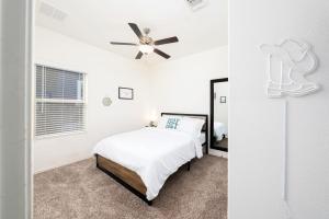 a bedroom with a bed and a ceiling fan at TONKA in Austin