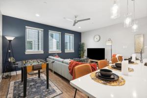 a living room with a couch and a table at The Charm 2BD In the Heart of Magnolia in Fort Worth