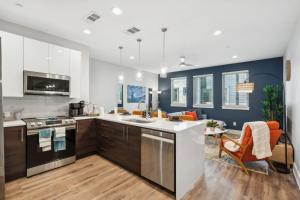 a kitchen with a sink and a stove top oven at The Charm 2BD In the Heart of Magnolia in Fort Worth