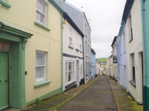 an empty street in ireland with colorful houses at 2 Bed in Appledore 53994 in Appledore +6 photos