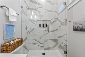 a bathroom with a shower and a sink at Elegant 2BD Townhome 7TH St Walkable in Fort Worth +49 photos