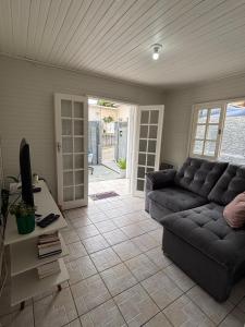 a living room with a couch and a table at Casa na Beira Mar Continental in Florianópolis