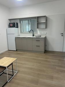 an empty kitchen with a sink and a refrigerator at Yarin's apartment in Qiryat Shemona