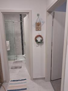 a bathroom with a shower and a toilet and a door at Atkacs Home in Győr +21 photos