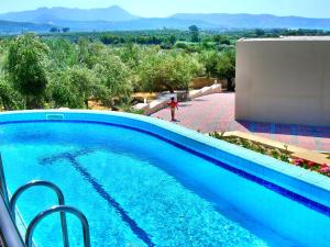 a blue swimming pool with a view of the mountains at Sirocco in Kissamos
