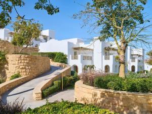 a villa with a garden and a road at Hotel Novotel Sharm El-Sheikh in Sharm El Sheikh