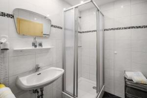 a white bathroom with a sink and a shower at Appartement Nr 2 Haus Voglreiter in Kaprun +31 photos