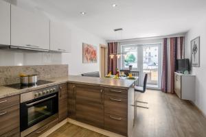 a kitchen with wooden cabinets and a counter top at Appartement Nr 2 Haus Voglreiter in Kaprun
