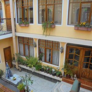 a building with lots of windows and potted plants at Chimborazo in Riobamba