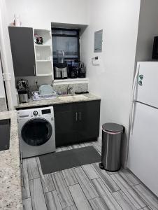 a kitchen with a washing machine and a refrigerator at Central Park Northwest Corner - Harlem in New York +10 photos