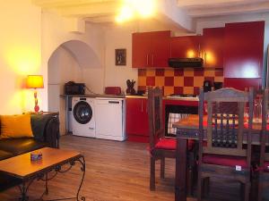 a living room with a kitchen and a living room with a table at Chez Béa in Pleumartin