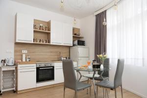 a kitchen with a table and chairs in a kitchen at Mrežnički kutak in Duga Resa