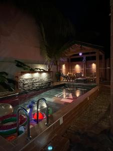a swimming pool at night with a swimming pool at Suite privée-chambre, salon et cuisine complete in Mbour +33 photos
