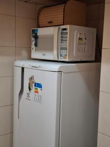 eine Mikrowelle auf einem Kühlschrank in der Unterkunft Oasis do Leme in Rio de Janeiro