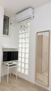 a room with a white wall with a window at Ginevra house in Naples +29 photos