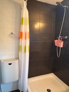 a shower with a colorful shower curtain in a bathroom at Espacio exterior cómodo- Tu planta baja rústica - Besiberri 7 in Pla de l'Ermita +18 photos