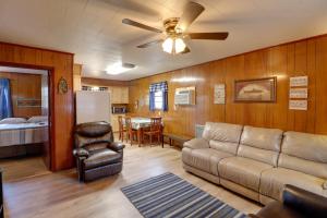 a living room with a couch and a ceiling fan at Pet-Friendly Cabin with Designated Boat Slip! in Fairfield Bay