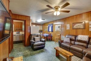 a living room with a couch and a table at Pet-Friendly Cabin with Designated Boat Slip! in Fairfield Bay