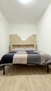 a bedroom with a large bed in a white room at Ginevra house in Naples