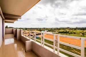 a balcony with a view of a field at Hotel O Thirumala Boarding & Lodge in Bengaluru