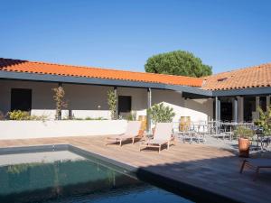 a patio with chairs and a swimming pool next to a house at ibis Montauban in Montauban