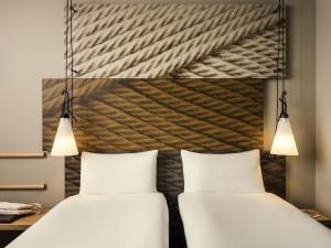 Ένα ή περισσότερα κρεβάτια σε δωμάτιο στο ibis Paris Place d’Italie 13ème