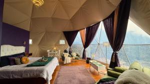 a bedroom with a tent with a large window at Felisa Rainforest Domes in Monteverde Costa Rica
