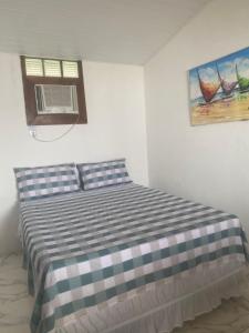 a bedroom with a bed and a window and a window at ElRancho Suites in Itaparica Town