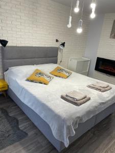 a bedroom with a bed with towels on it at Apartament w centrum in Rymanów-Zdrój +21 photos