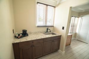 a kitchen with a sink and a counter top at Seashell Motel in Key West +27 photos