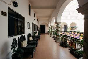 a hallway with chairs and tables in a building at Hotel Nueva Antequera in Oaxaca City