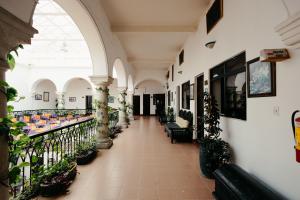 a hallway with potted plants in a building at Hotel Nueva Antequera in Oaxaca City