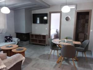 a living room with a couch and a table and chairs at Villa Joanna 4 in Mesimérion