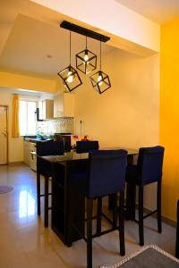 a kitchen with a table and chairs in a room at Serenity Casa in Talaulim