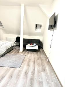 a living room with a bed and a tv at Aparthotel in Chemnitz