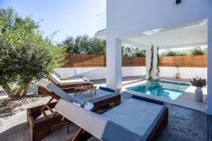 a backyard with a swimming pool and a house at Villa Maria Cameo in Laganas