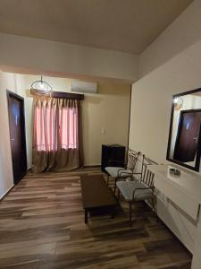 a room with chairs and a television and a window at Ghazala Bay Hotel in Dahab +26 photos