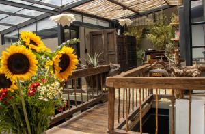 a greenhouse with sunflowers on a wooden deck at Hotel Quinta Bolivar in Bogotá