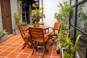 a table and chairs on a patio with plants at Hotel Quinta Bolivar in Bogotá