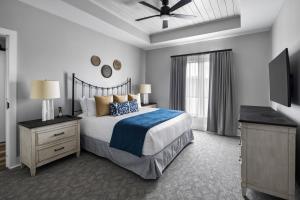 a bedroom with a bed and a dresser and a television at Nicewonder Farm & Vineyards in Bristol