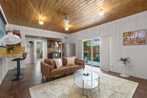 a living room with a couch and a table at Zen Beach House, Steps From Atlantic Ave And Beach in Delray Beach